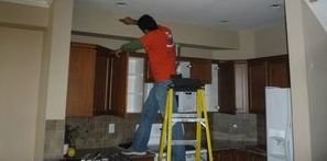 Professional Repairing A Ceiling During A Blizzard